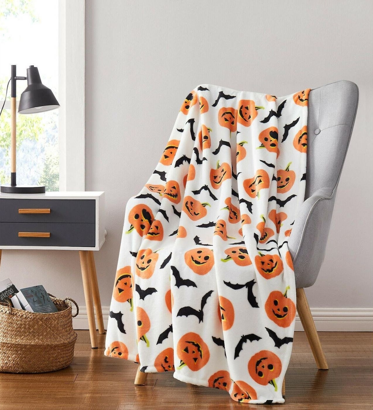 the bat and pumpkin patterned blanket on a chair