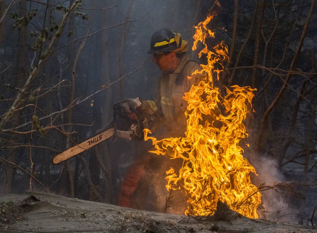 Martin Goldberg is shown in fire gear with a chainsaw as flames burn in front of him