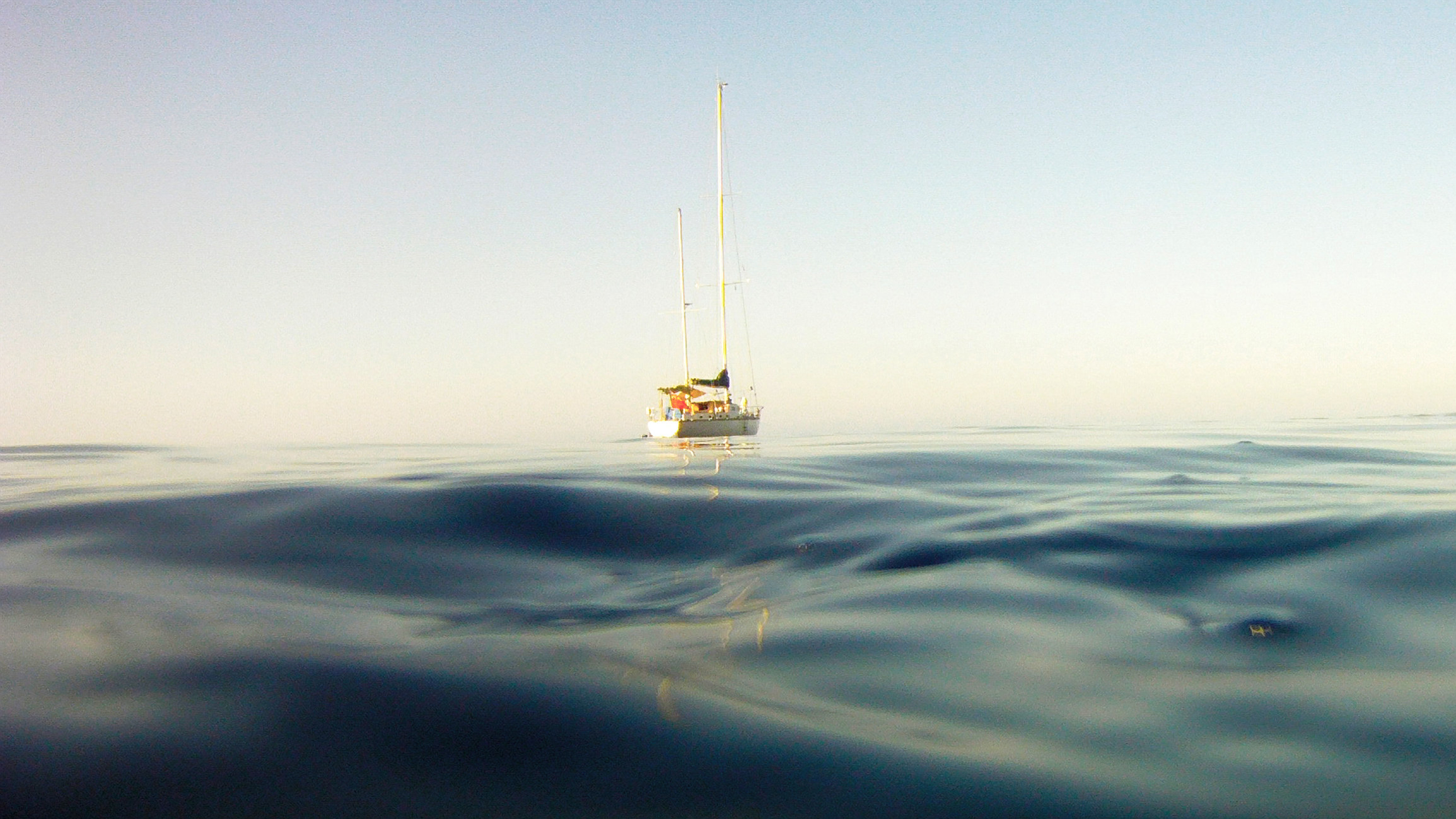 A sailboat in the middle of the ocean