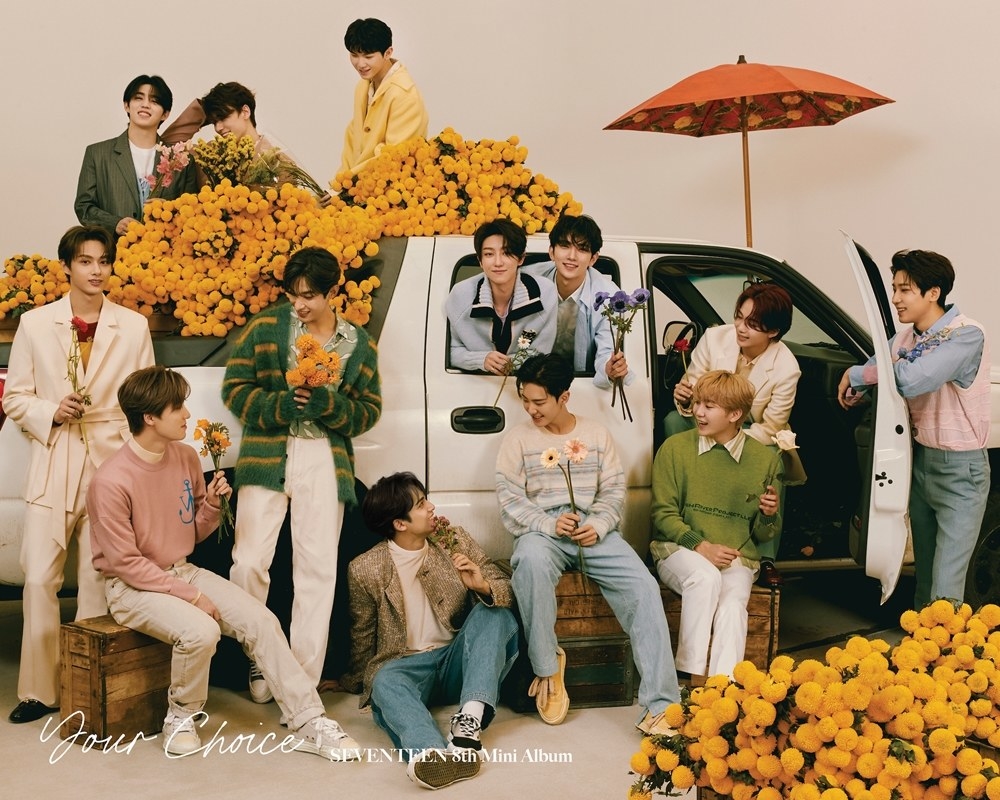 Seventeen poses around a truck full of flowers for their eighth mini album Your Choice.