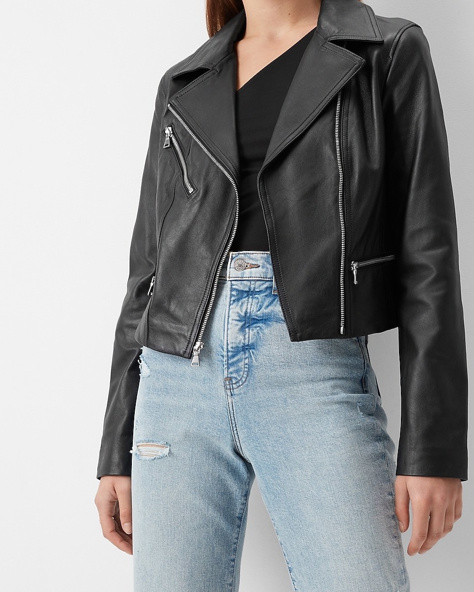 A model wearing a black leather moto jacket
