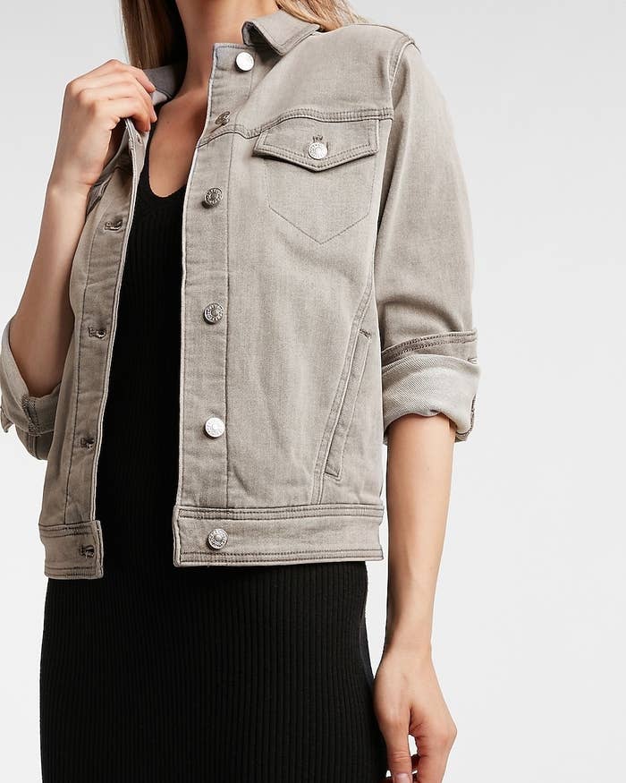 A model wearing a grey denim trucker jacket