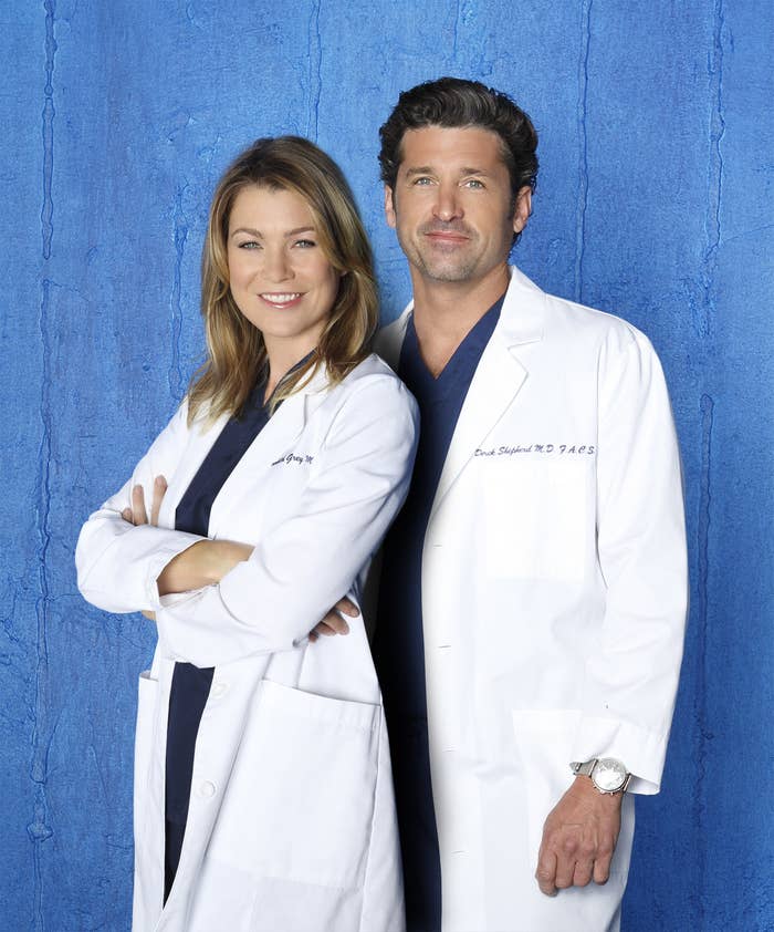 Ellen Pompeo crosses her arms with her back to Patrick Dempsey in matching lab coats