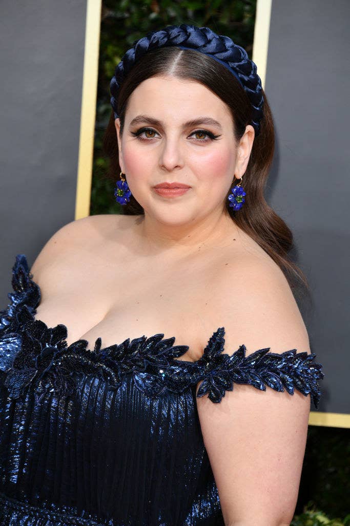 Beanie at the Oscars in a metallic off-the-shoulder gown with matching headband