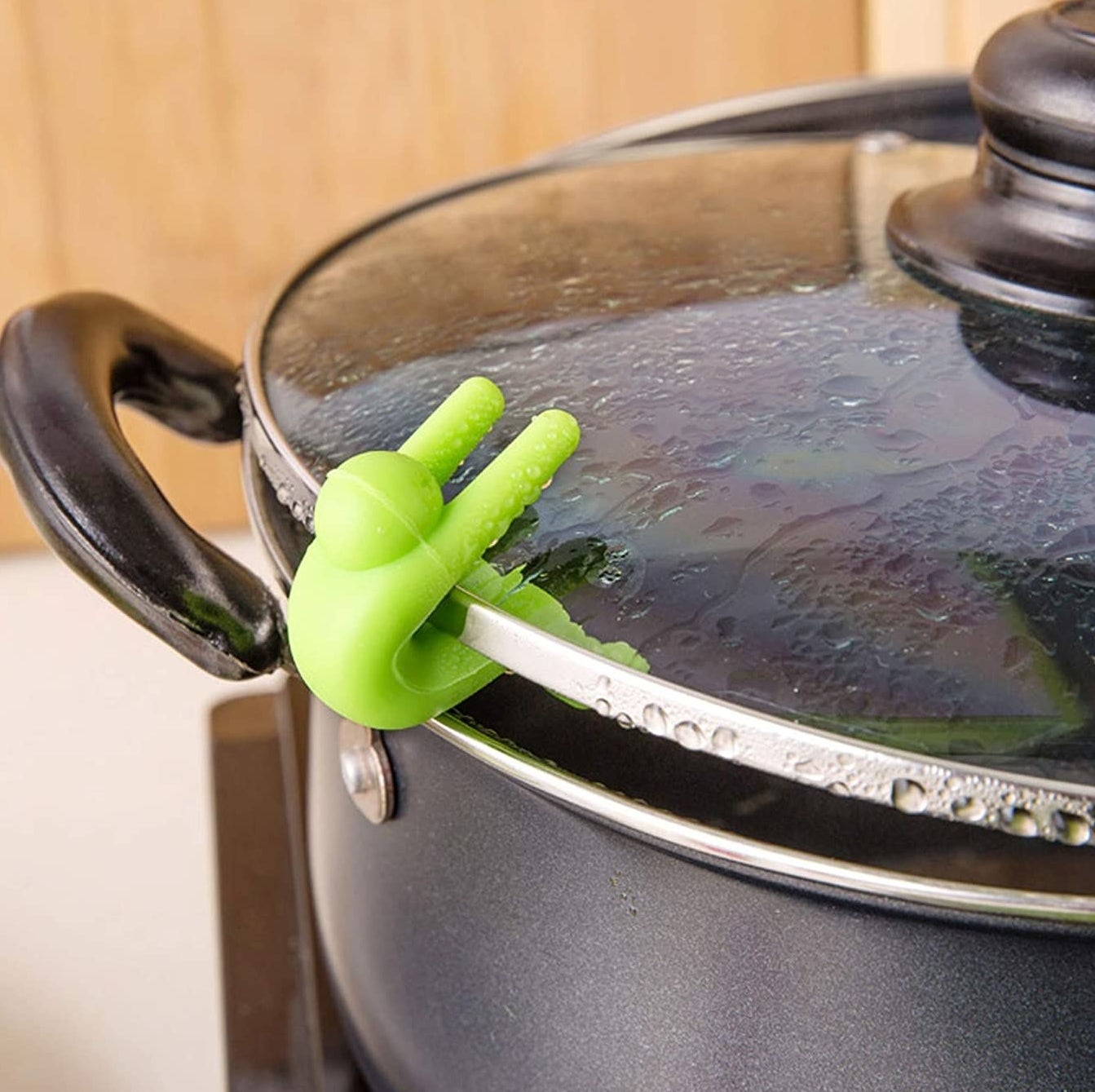 A lid lifter holding a lid ajar