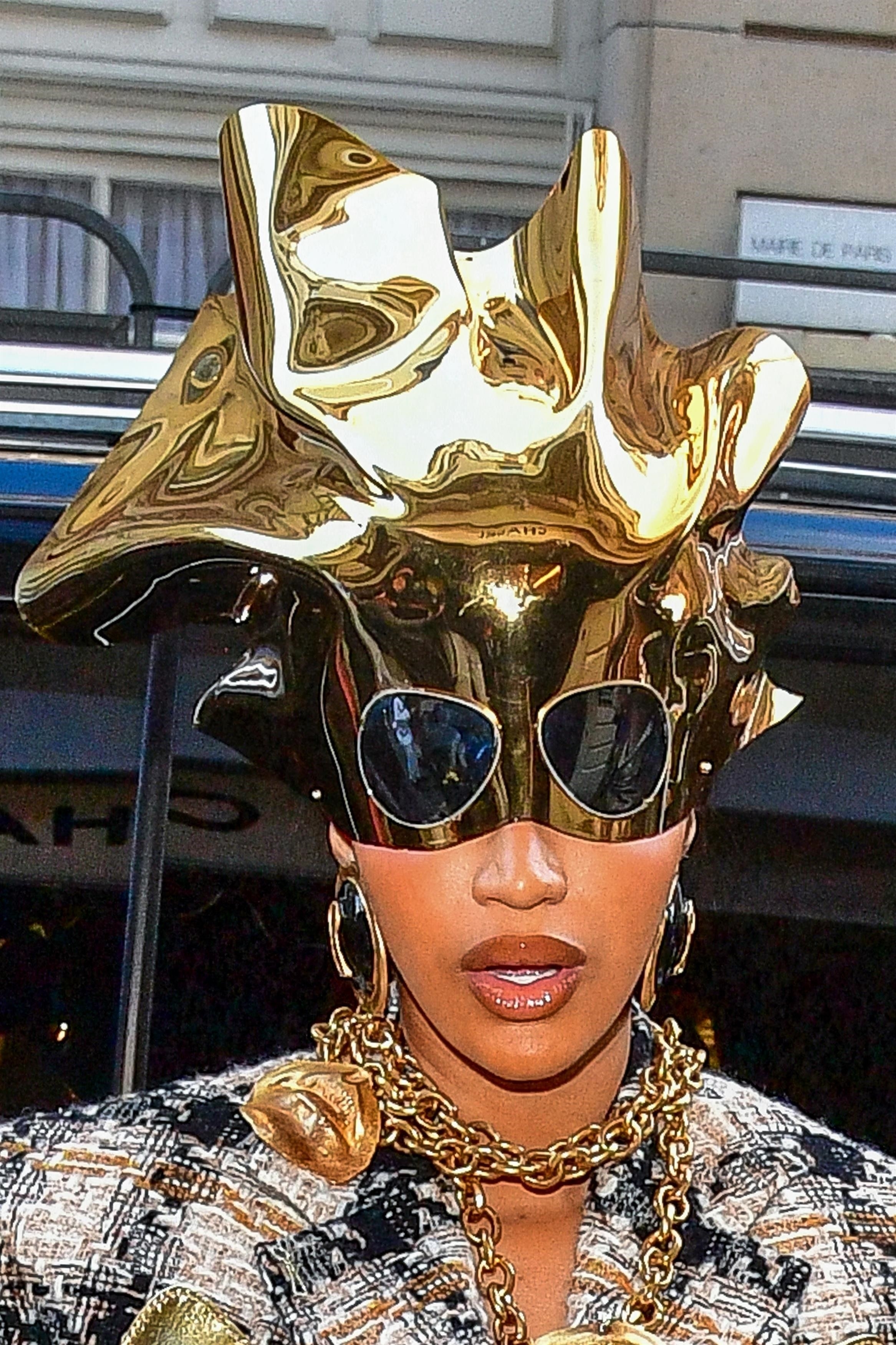 Close-up of Cardi&#x27;s gold headpiece, with attached sunglasses