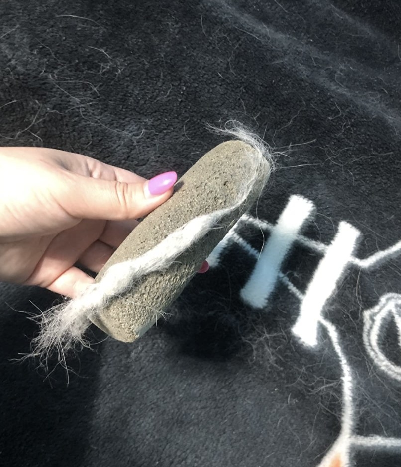 reviewer holding the fur remover with fur attached to it