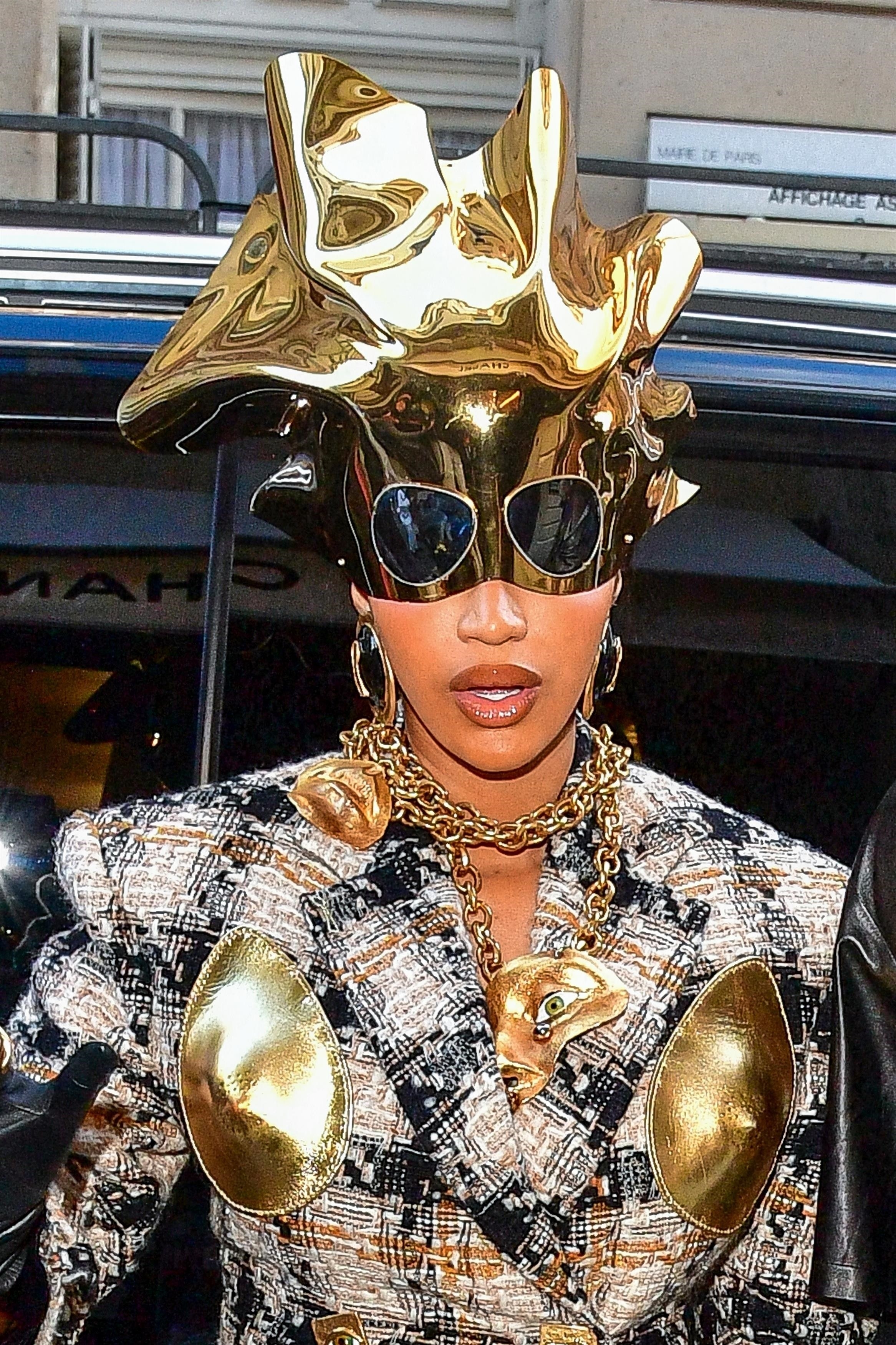 Close-up of Cardi&#x27;s gold headpiece, with attached sunglasses