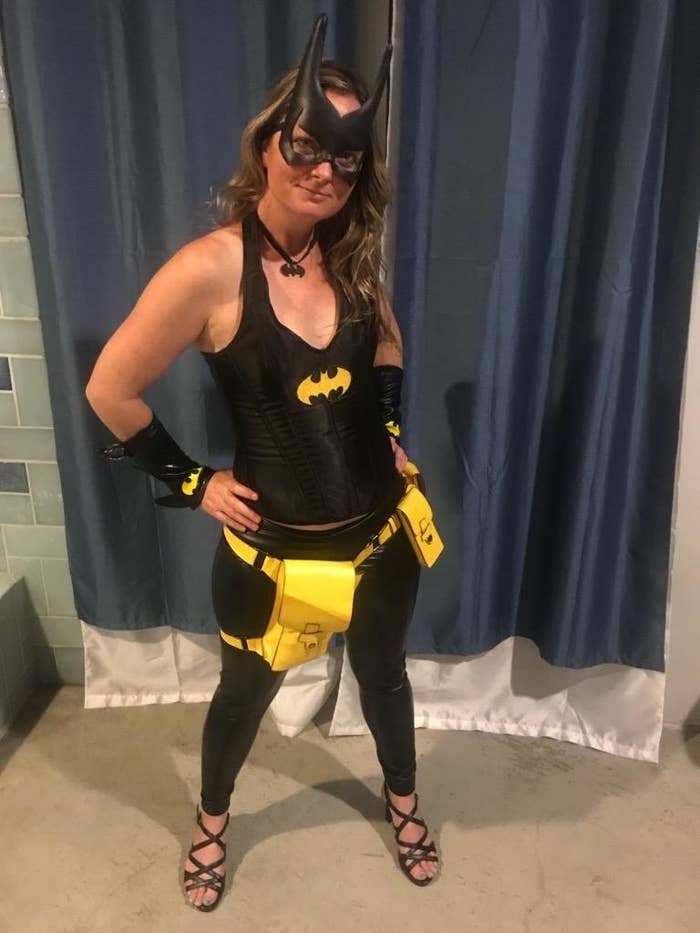 reviewer wearing the black leggings for a batgirl costume