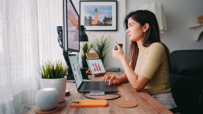 Woman looking at graphs on her computer