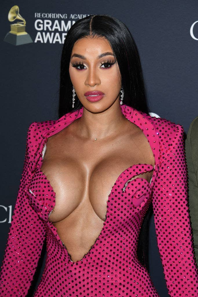 Cardi at the Grammys in a bedazzled gown with a deep V-neck that extends down to her midriff