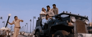 A policeman throws a street-light on men who&#x27;re travelling in a jeep