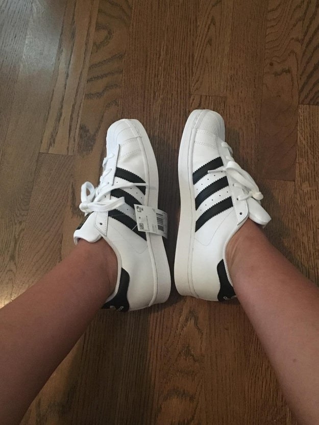 Reviewer photo of them wearing the white and black Adidas shoes