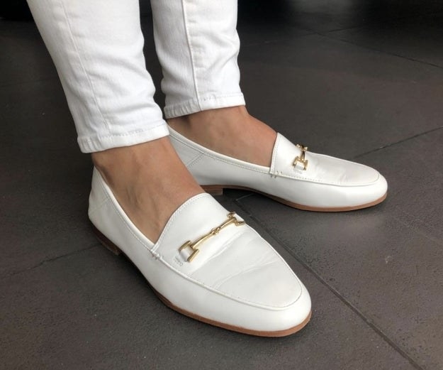 Reviewer photo of white loafers with gold buckles on top