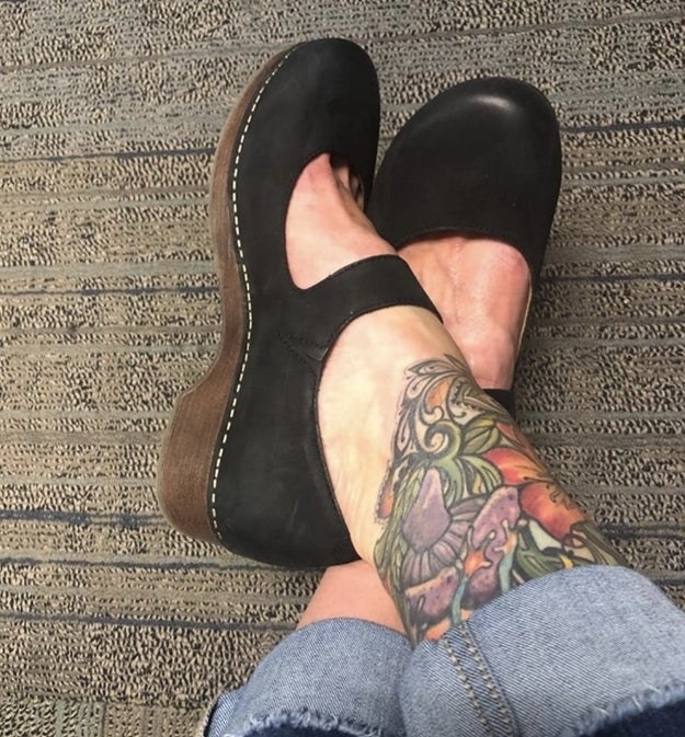 Reviewer photo of the black clogs with brown soles