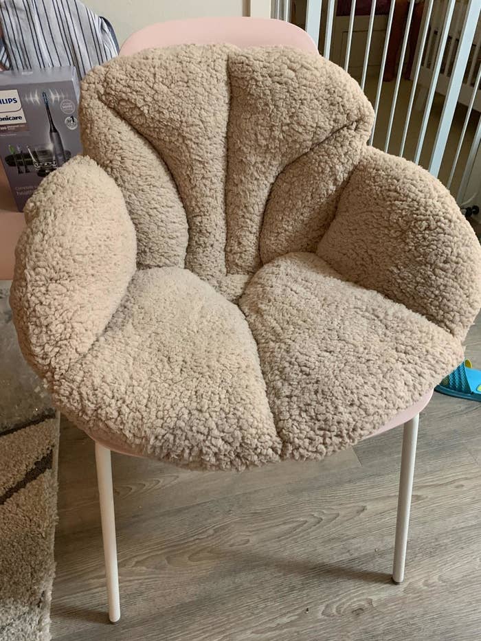 the tan cushion on a hard back chair