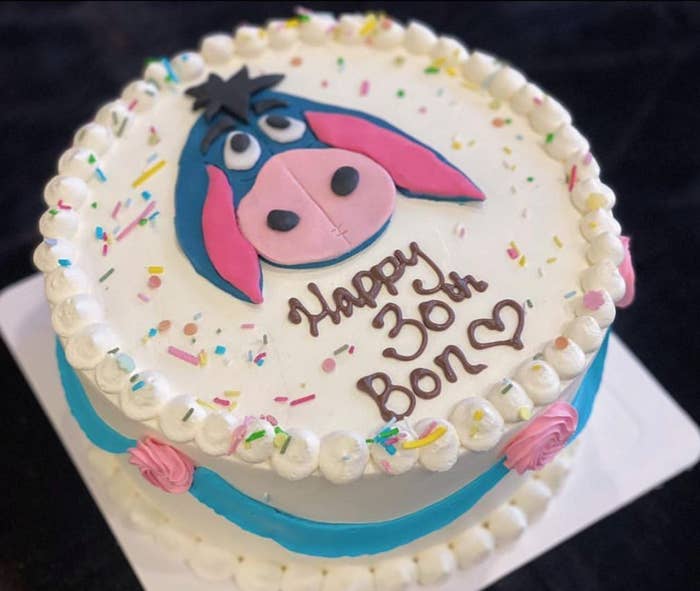 A birthday cake with the character Eeyore from &quot;Winnie the Pooh&quot; on it and the words &quot;Happy 30th Bon&quot;