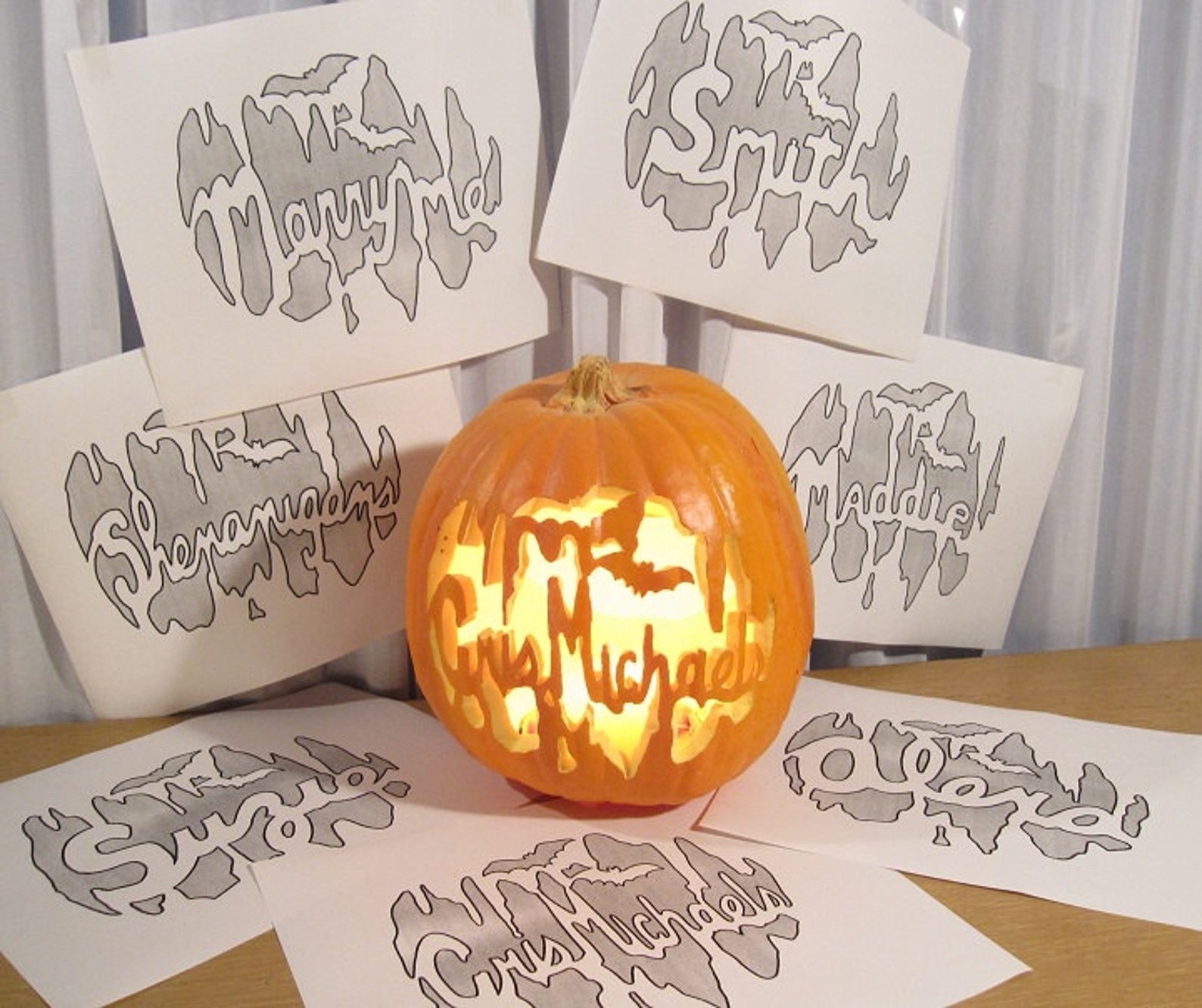 pumpkin with name carved on it with other custom patterns around it