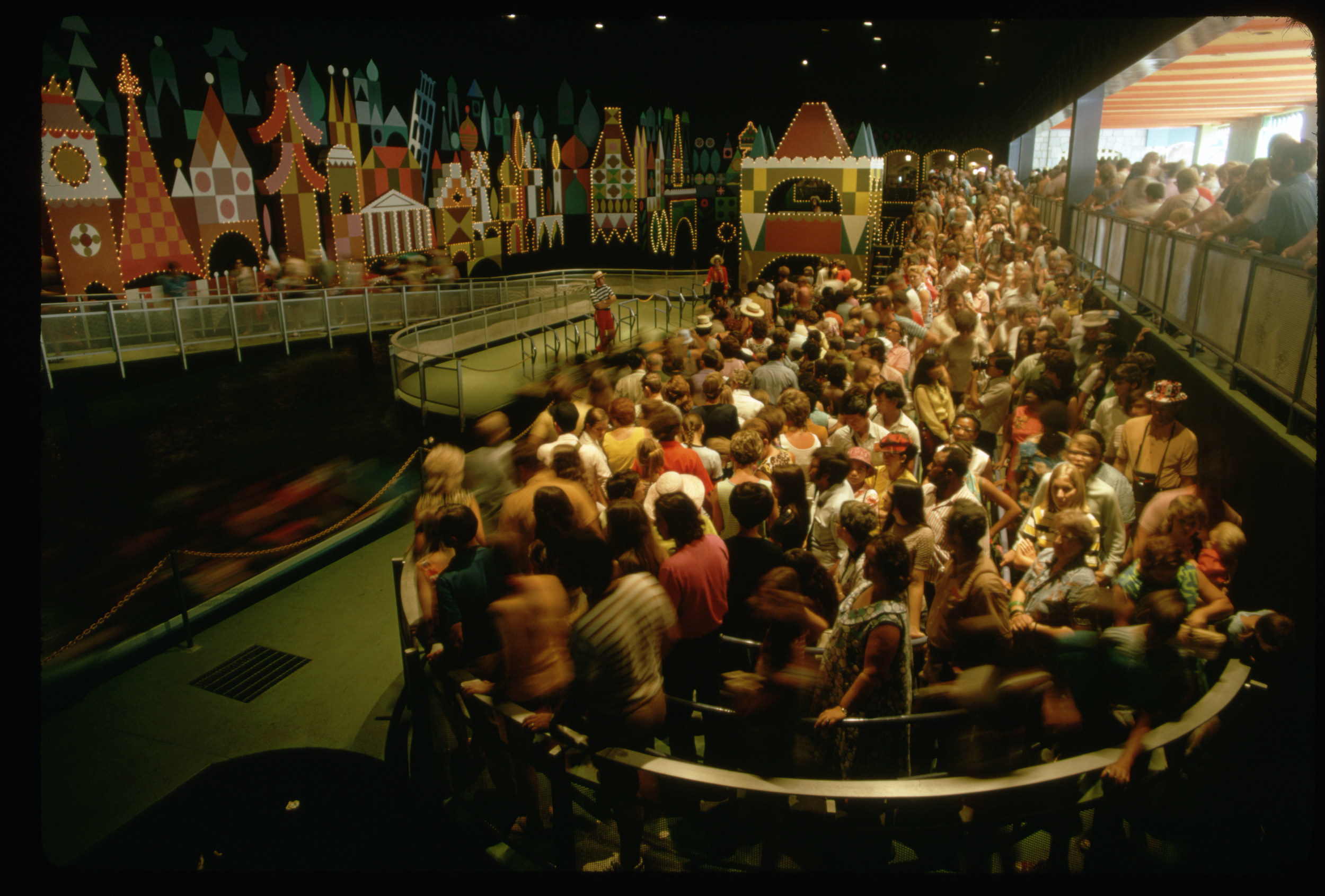 Hundreds of people queue in a line to enter Disney World