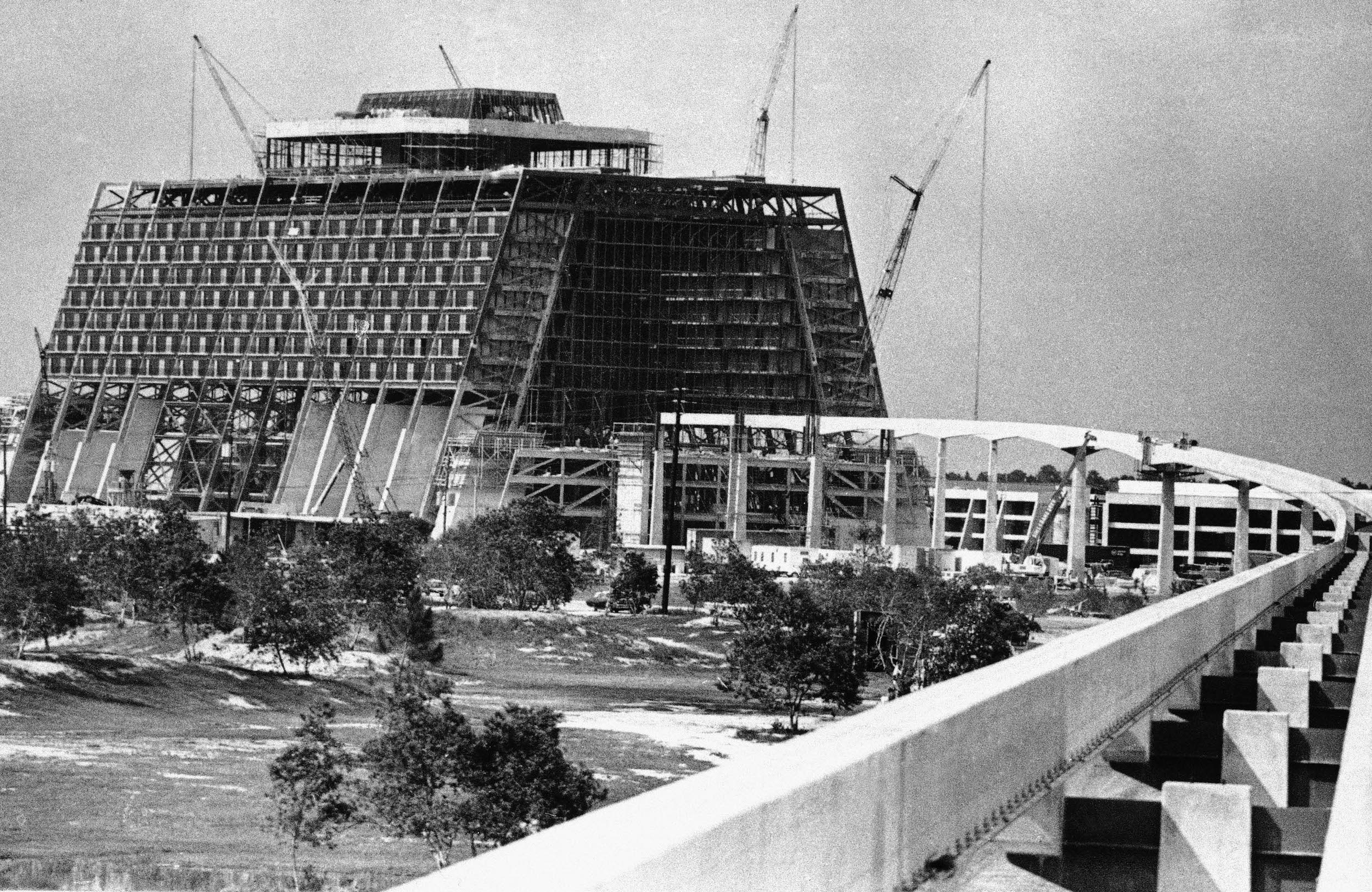 An architectural view of a hotel and train line under construction 