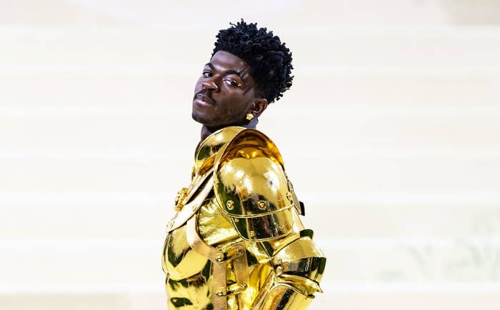Lil Nas X in a gold armor suit on the steps of the Met Gala