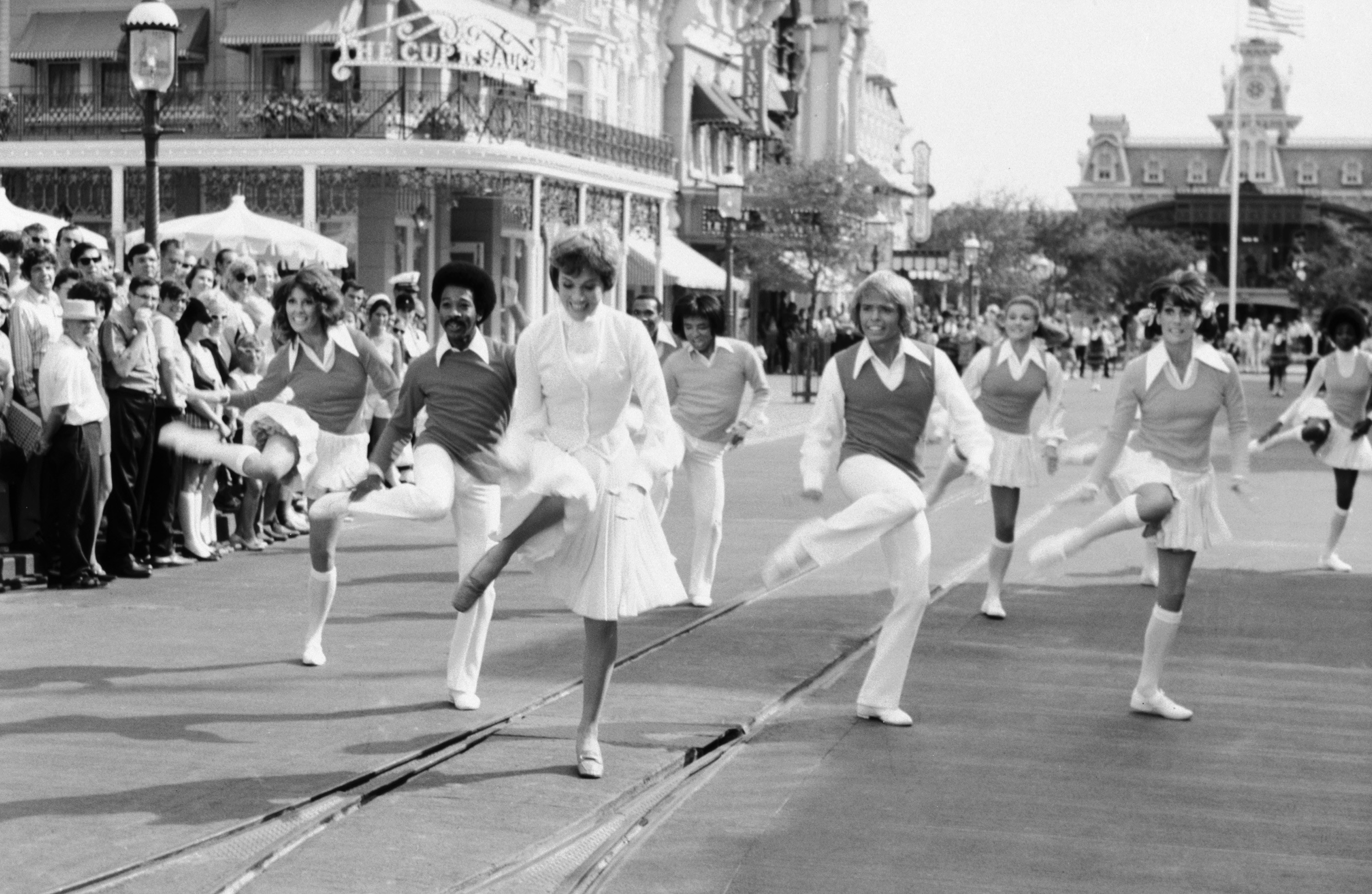 Julie Andrews performs a dance in the street at Disney World