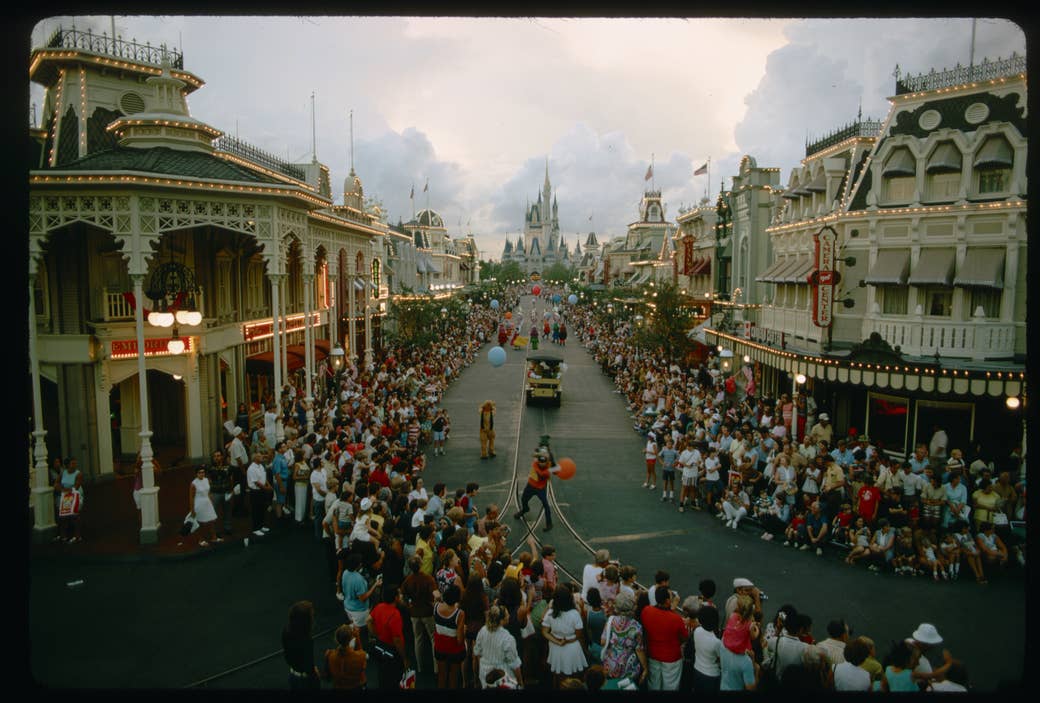 Crowds watch a parade on Main Street at Walt Disney World Resort