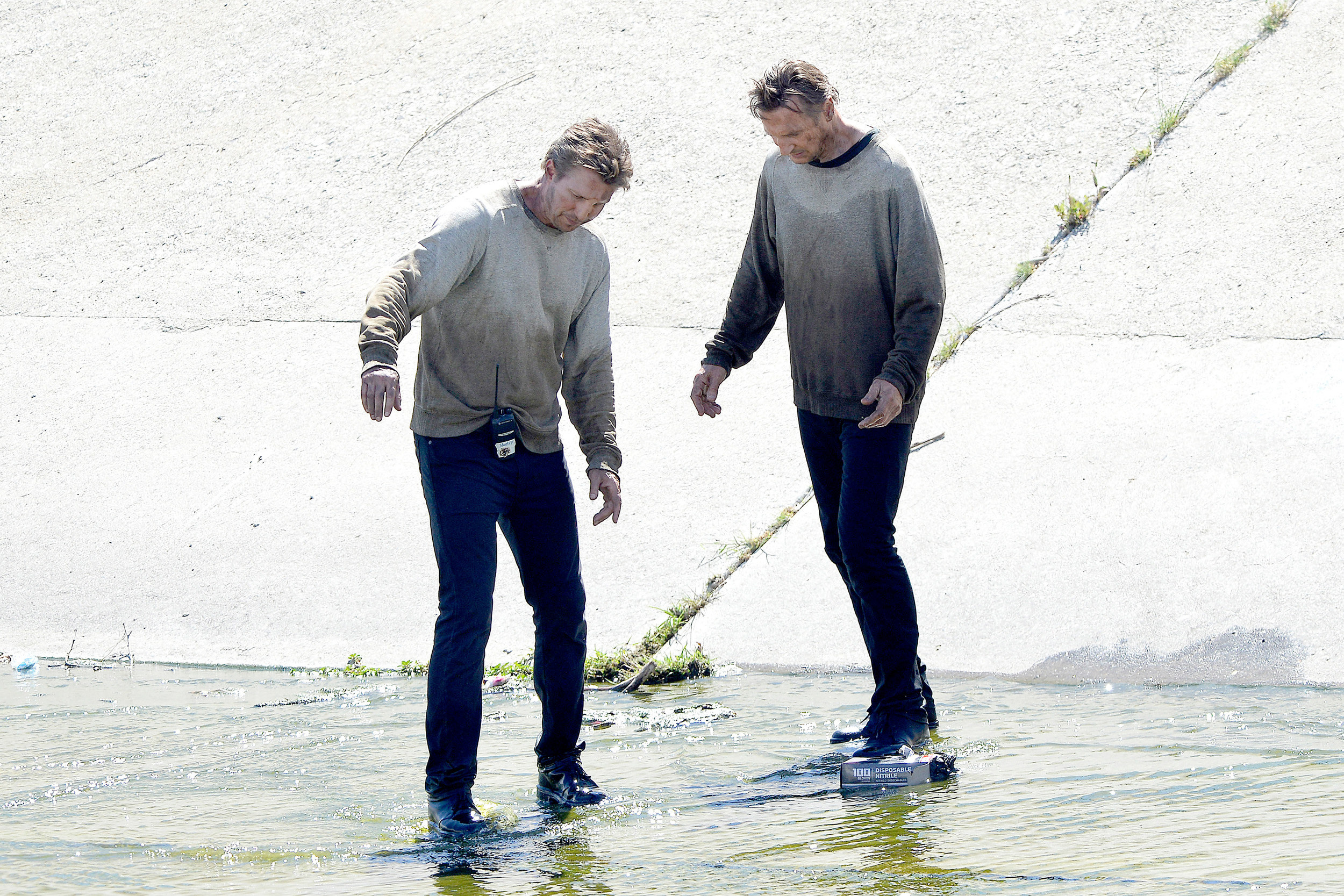 Liam Neeson and his stunt double stepping in water while filming