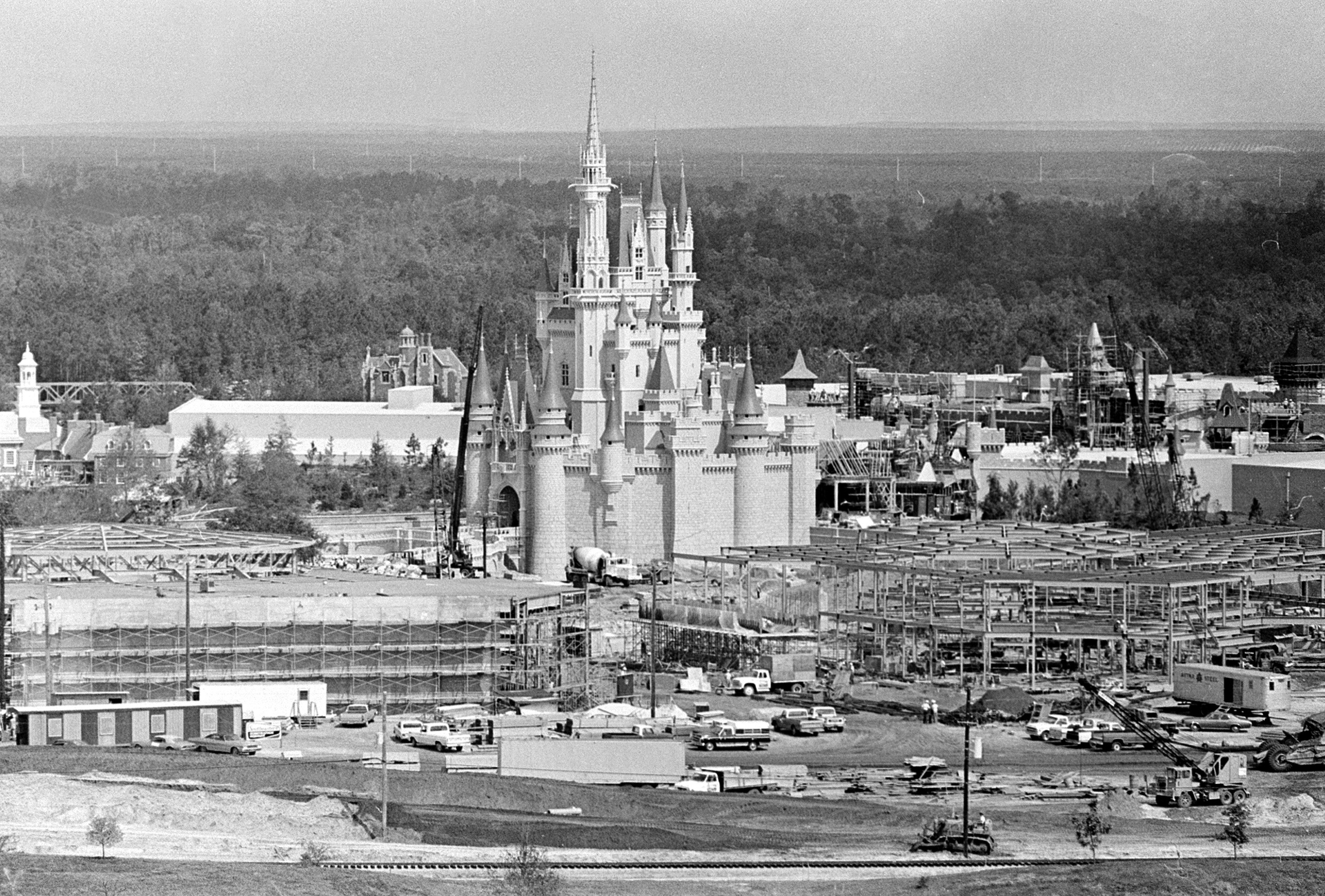 An open landscape view of construction site for Disney World with a castle in the middle