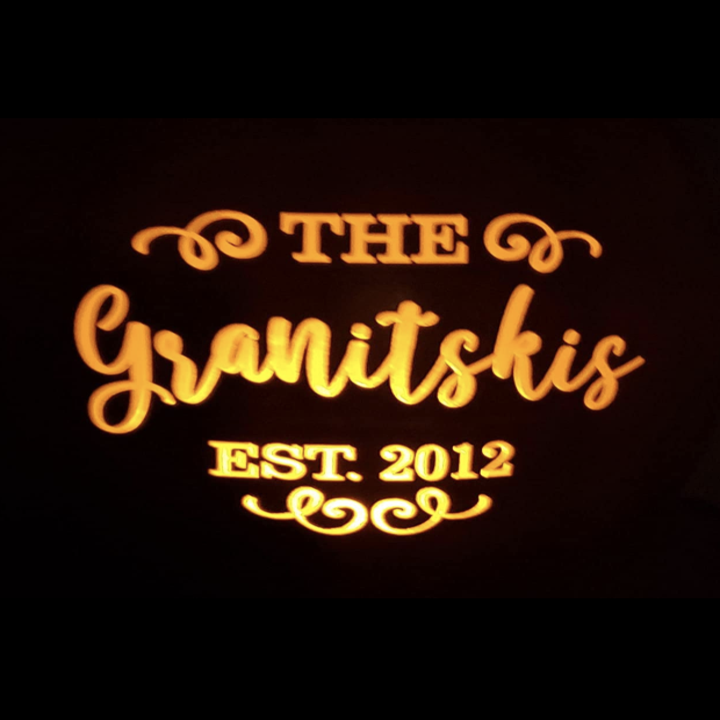 view of the famly name lit up in the pumpkin in the dark