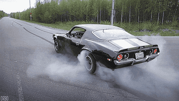A GIF of a muscle car spinning its tires