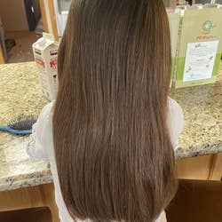 Reviewer's child now with smooth hair from using the brush