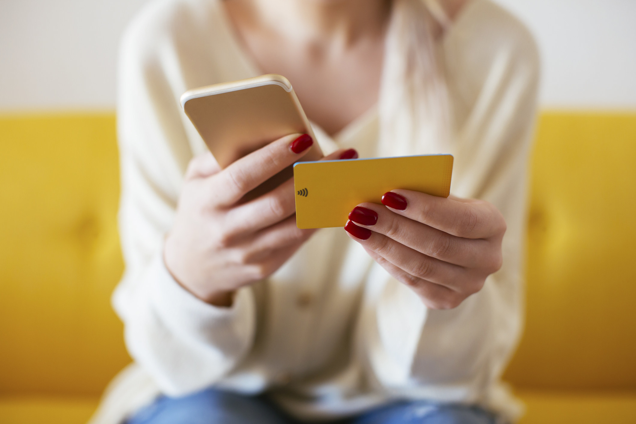 Woman holding a phone and a credit card