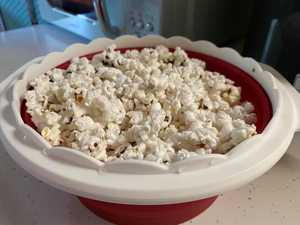 the red bowl with popcorn inside it
