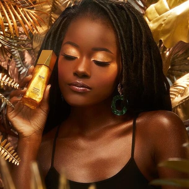 model holding the bottle of gold shimmer