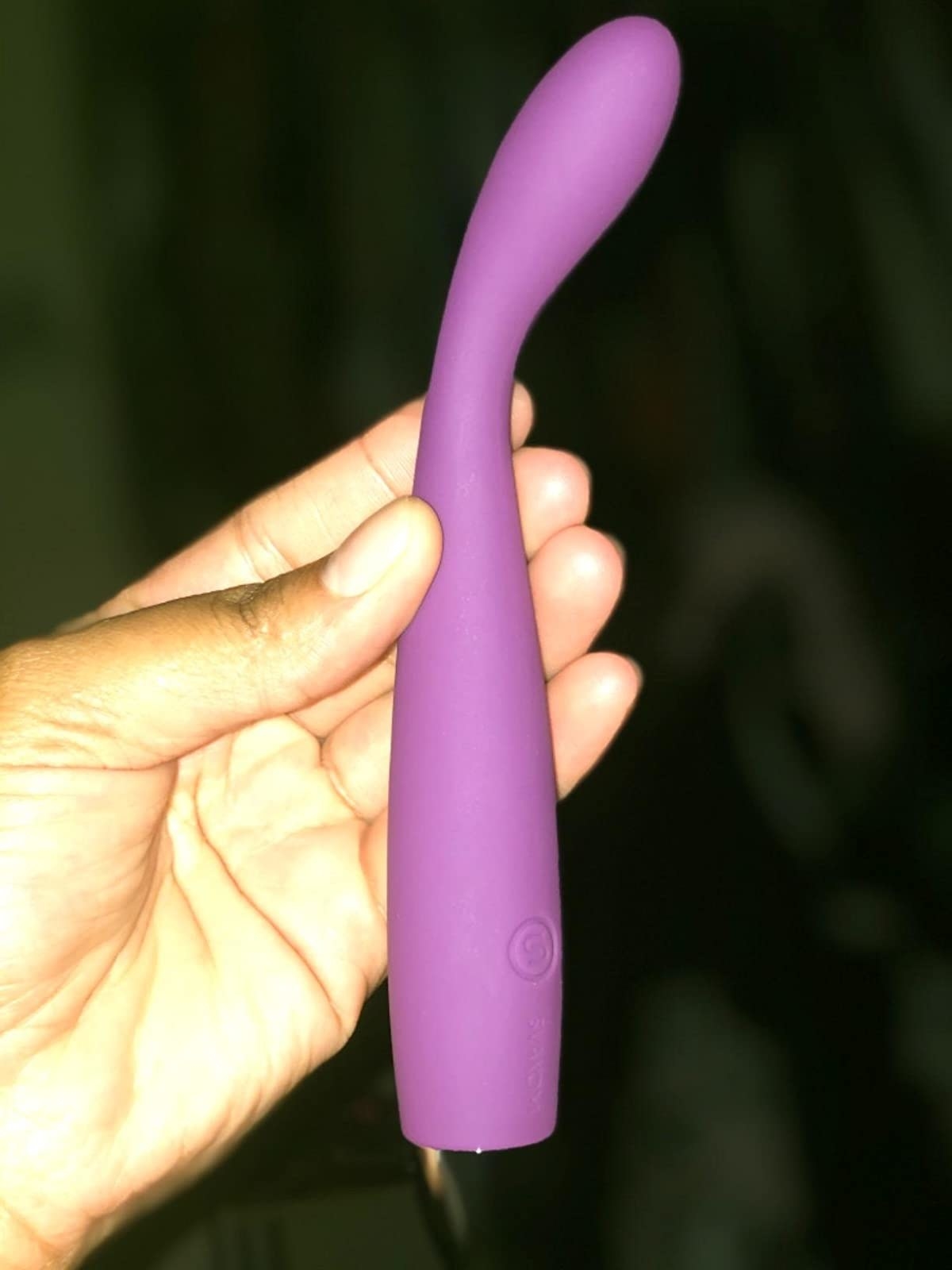 Reviewer holding purple G-spot vibrator