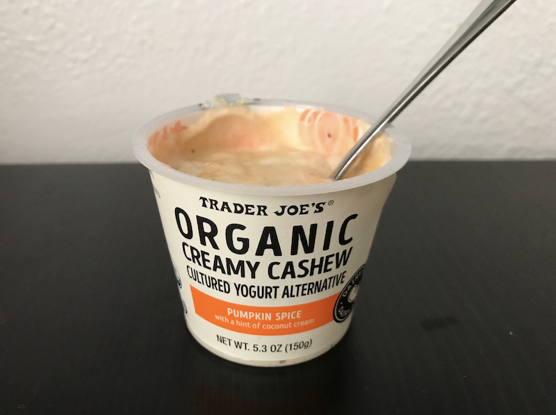 A container of Organic creamy cashew cultured yogurt alternative flavored with pumpkin spice and a hint of coconut cream