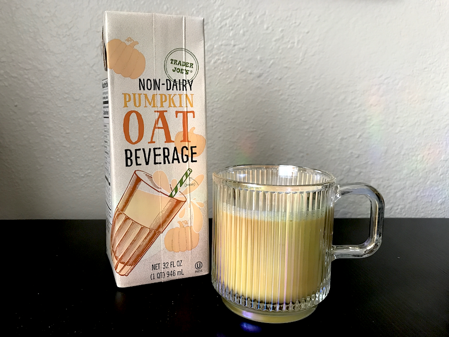 A carton of pumpkin oat beverage and a glass of it