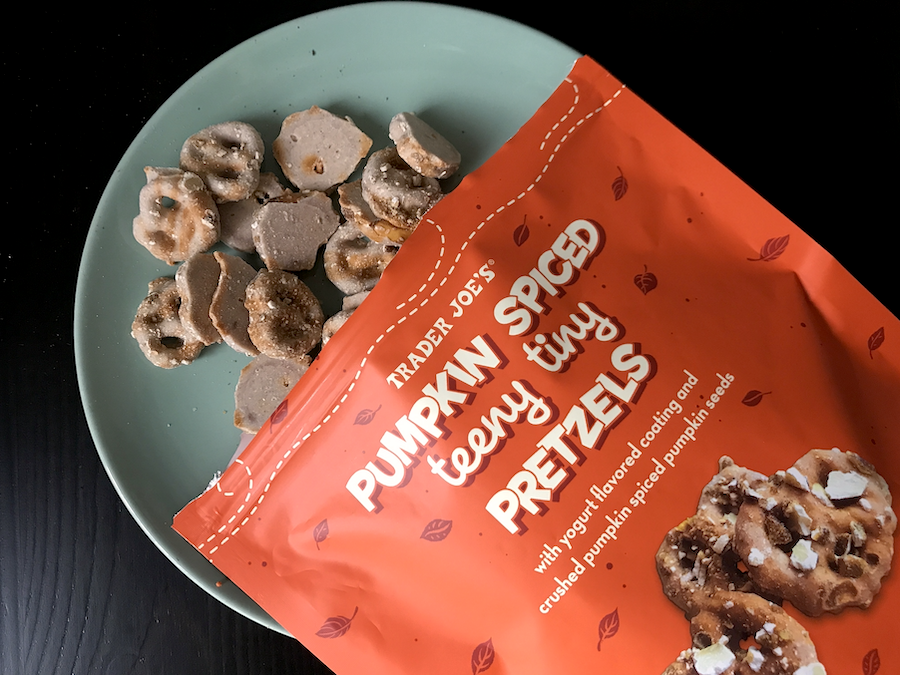 Pretzels with a pumpkin spice yogurt coating and crushed pumpkin spice pumpkin seeds on top