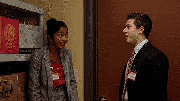 Devi and Ben Gross high-fiving in a supply closet
