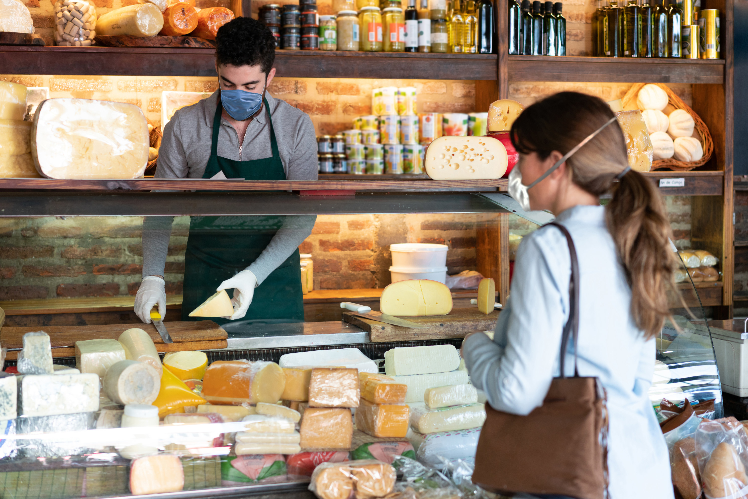 Woman buying cheese at a fancy cheese store