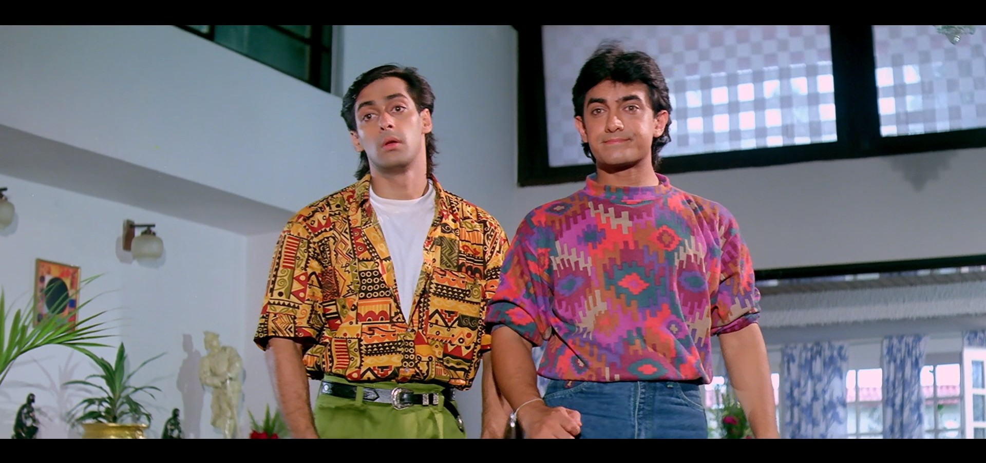 Amar and Prem in colourful tees looking constipated