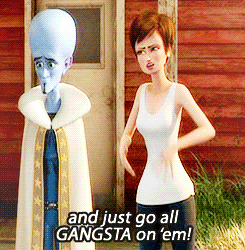 Megamind and Roxanne are standing there. Roxanne is saying &quot;and just go all gangsta on &#x27;em!&quot;.
