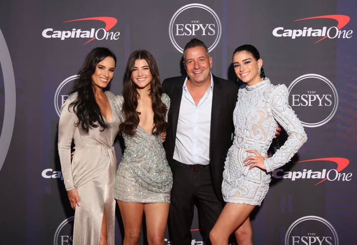 The D'Amelio sisters posing on the ESPYS red carpet with their parents