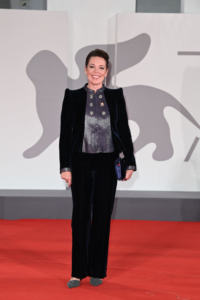Olivia Colman wearing a plush navy velvet suit with silver trimmings on the red carpet for &quot;The Lost Daughter&quot;