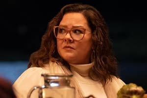Melissa McCarthy sitting outside at a table