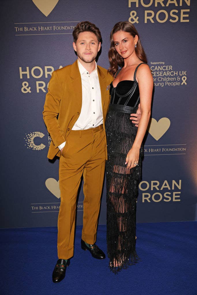 The couple posing at a red carpet event