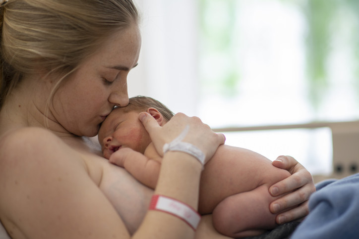 A person doing skin-to-skin contact with their newborn