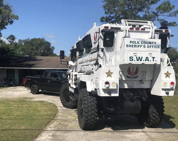 Armored vehicle with &quot;Polk County Sheriff&#x27;s Office SWAT&quot; on the back parked in a driveway
