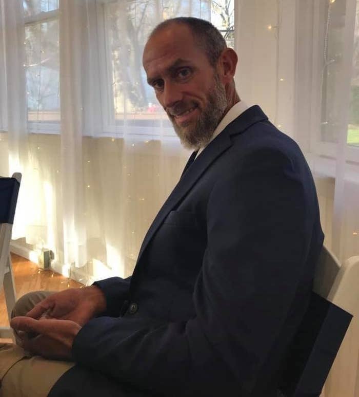 A man sitting by a window and looking at the camera